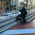 Going up stairs with handrail in a wheelchair